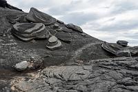 UFO Meeting  Unwillkürlich kommen einem angesichts der skurril geformten und von Brandung abgeschliffenen Lavascheiben diese Assoziationen. Der Weg zu den Entenkolonien ist beschwerlich, denn der schwarze Kies des Trampelpfades ist anstrengend zu begehen, weil man ständig halb auf dem schlüpfrigen Grund versinkt. Ein Ausweichen auf die begleitenden, wüst hingewürfelten Stein- und Lavafelder birgt hingegen die Gefahr eines Fußbruchs. Wir kommen nur langsam voran...