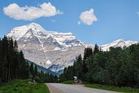 The Mountain of the Spiral Road  Nun ist es nicht mehr weit zu unserem heutigen Übernachtungsplatz am Fuße des sehr charakteristischen Mt. Robson, auf dessen Südflanke wir vom Parkeingang blicken. Er ist mit 3954 m der höchste Berg der kanadischen Rocky Mountains und sticht mit seiner von Schneeablagerungen hervorgehobenen Schichtstruktur unverkennbar aus der umliegenden Gebirgswelt heraus. In der Sprache der Secwepemc Indianer  (Shuswap)  heißt der Berg  Yuh-hai-has-kun , was soviel wie "The Mountain of the Spiral Road" bedeutet.