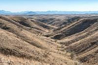 Dauerwelle  Wir passieren die Grenze von der  Khomas- zur Erongoregion, während sich das wieder aufsteigende Gelände zu einer ausgedehnten Hügellandschaft dehnt. Über viele Kilometer sieht es links und rechts der Straße aus wie auf diesem Bild.
